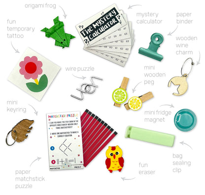 Collection of small items including a paper matchstick puzzle, fun eraser, and various other  gifts that you can found inside the PETIT `C`HRISTMS `CRACKERS SET OF 6