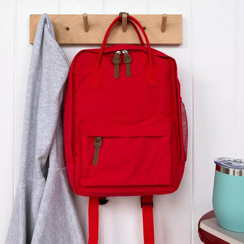 Compact everyday backpack in red with adjustable straps and multiple compartments