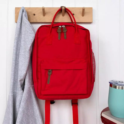 Compact everyday backpack in red with adjustable straps and multiple compartments