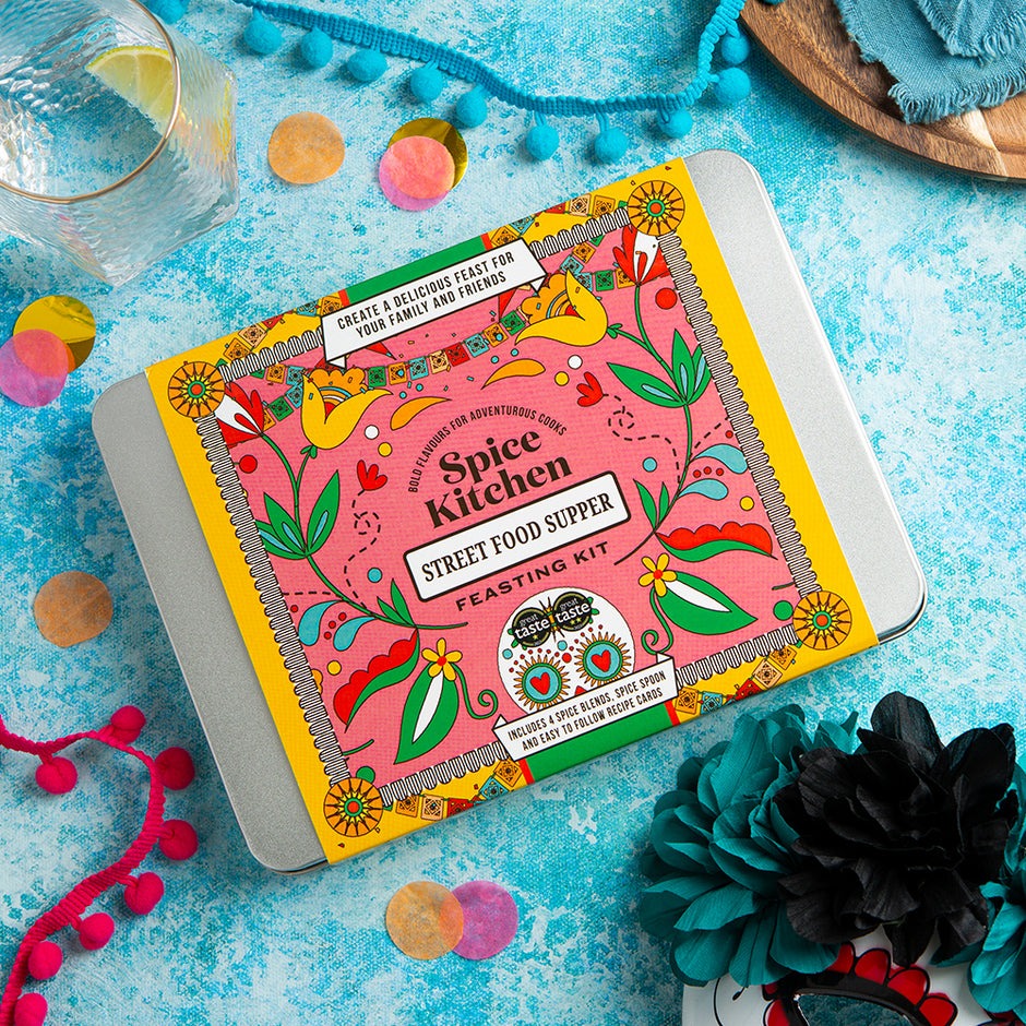 Spice Kitchen Street Food Supper kit on a blue textured surface with decorative elements.