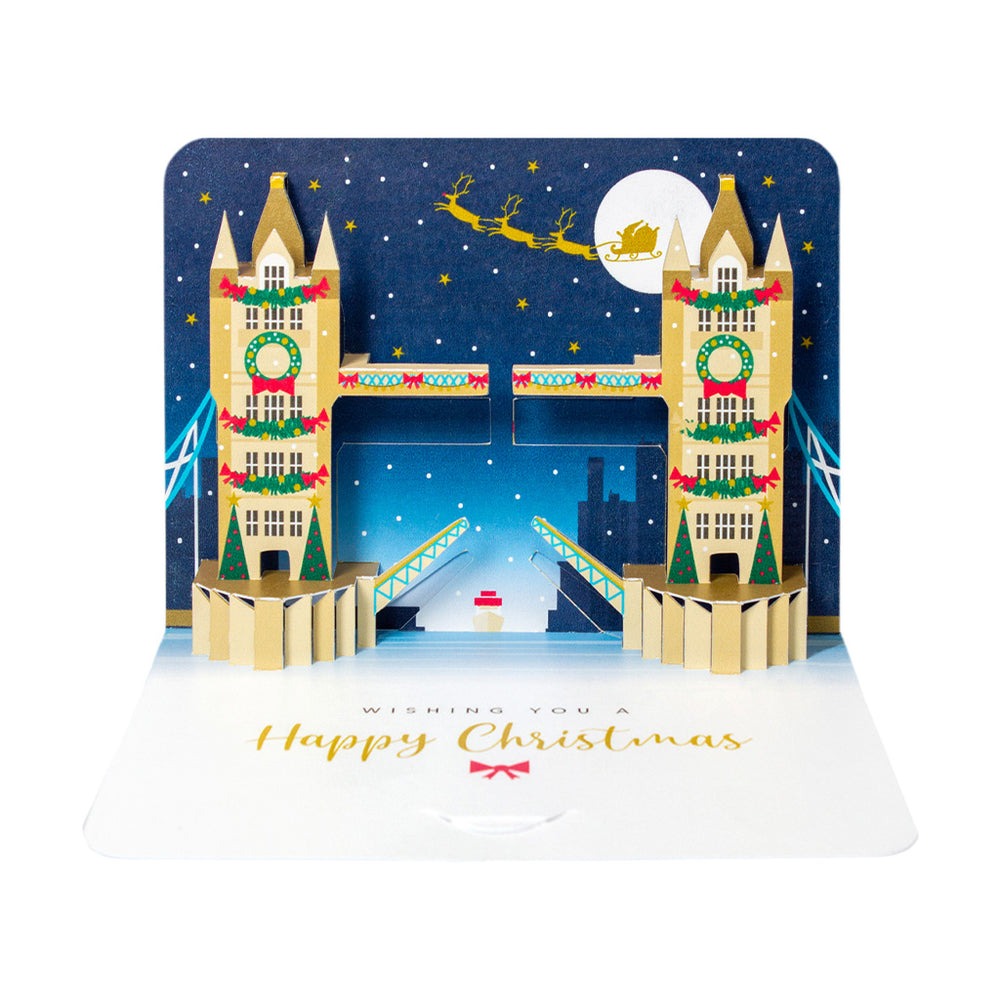 3D Christmas card featuring snowy Tower Bridge London scene, die-cut and cold foil finish, 280gsm textured card, white envelope, blank inside, made in the UK.
