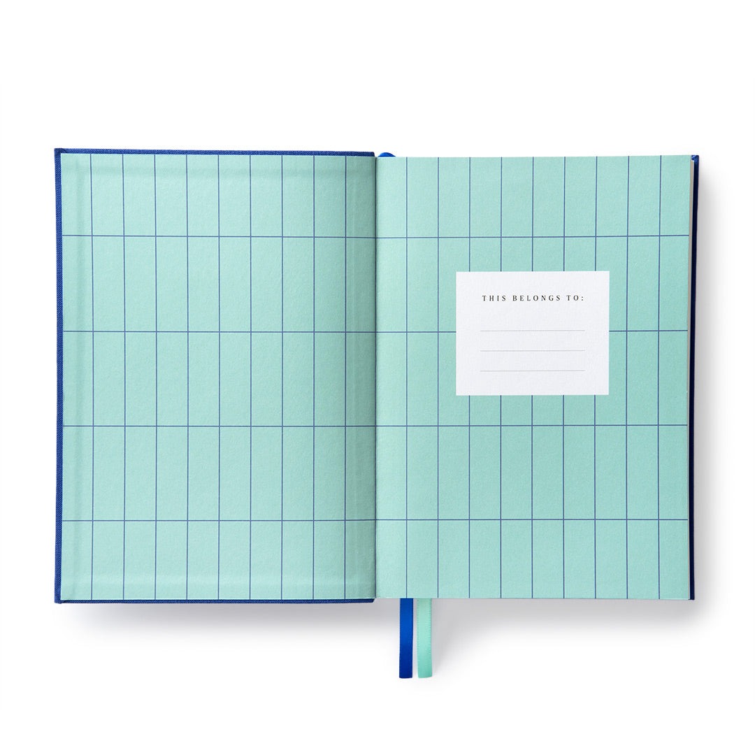 ULtramarine Fabric Daily Planner B6 open to the “This Planner Belongs To” page.