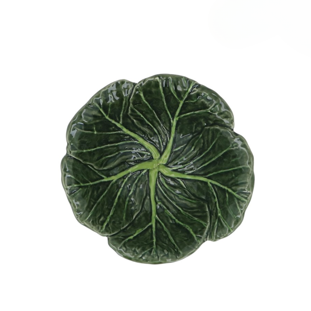 A green stoneware bowl designed to resemble a cabbage leaf.