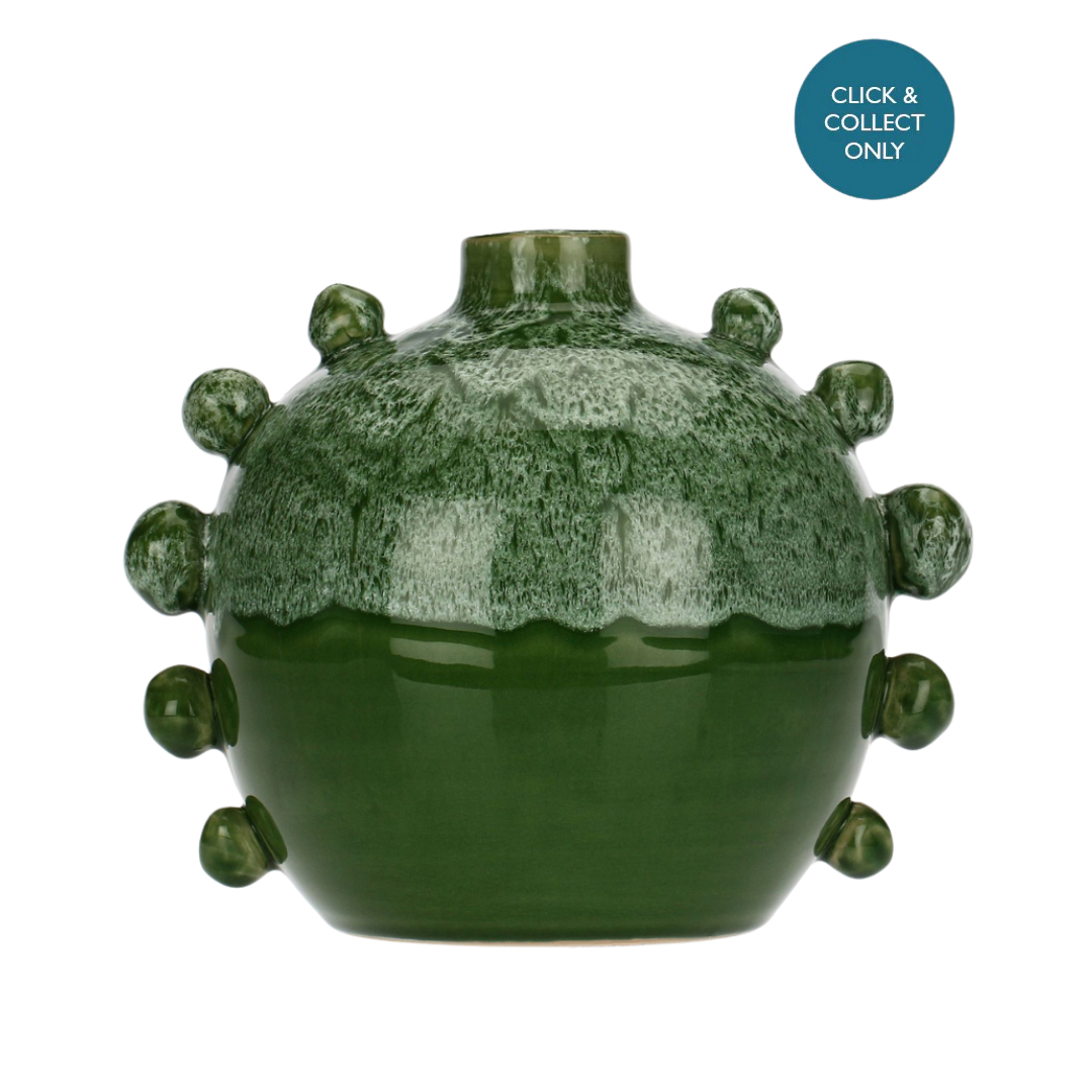 A decorative terracotta vase with a bold two-tone color block, featuring deep green at the base and a lighter green on top, with a distinctive decorative handle on the side.