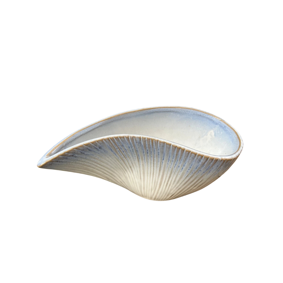 Side view of the Blue ombre stoneware shell bowl with seashell-inspired design, decorative coastal-style centrepiece for home décor on a white background