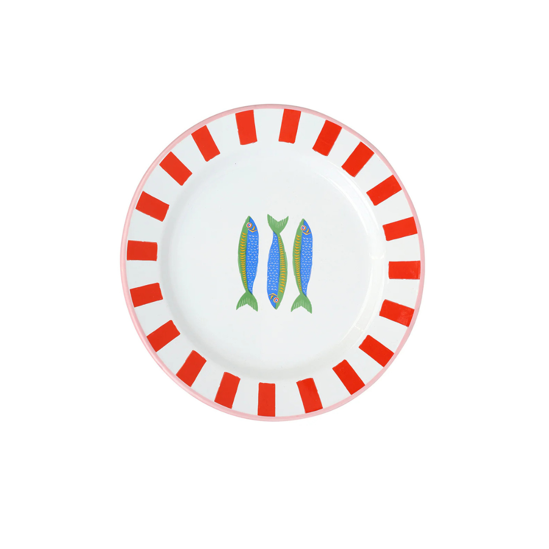 Enamel plate with red stripes, pink trim, and three illustrated sardines in the center.
