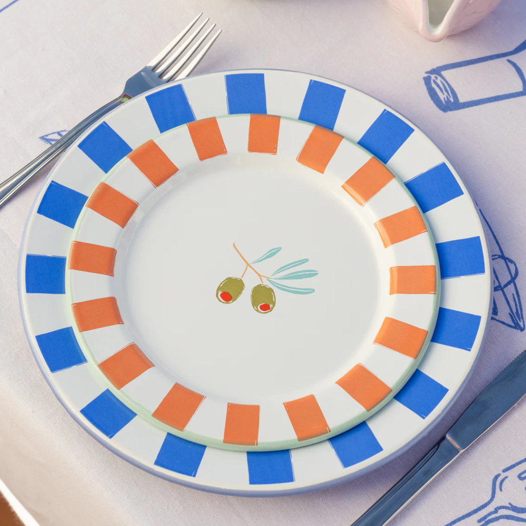 Handcrafted olive-themed enamel plate with bold orange stripes and two olives in the center, olive green trim on underside, 20cm diameter, durable and dishwasher safe.