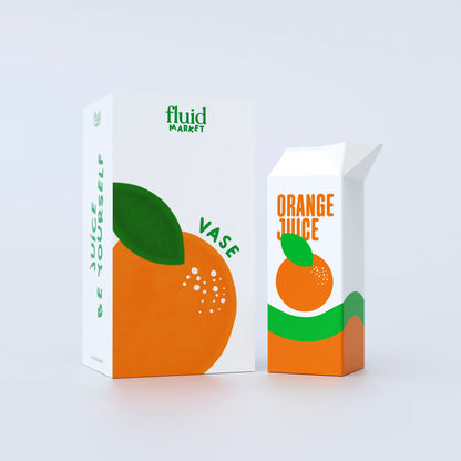 Ceramic Orange Juice Vase with matching cardboard packaging. Quirky plant holder shaped like a juice carton on a white background. `Perfect for modern home decor, plant lovers, and playful shelf styling. 