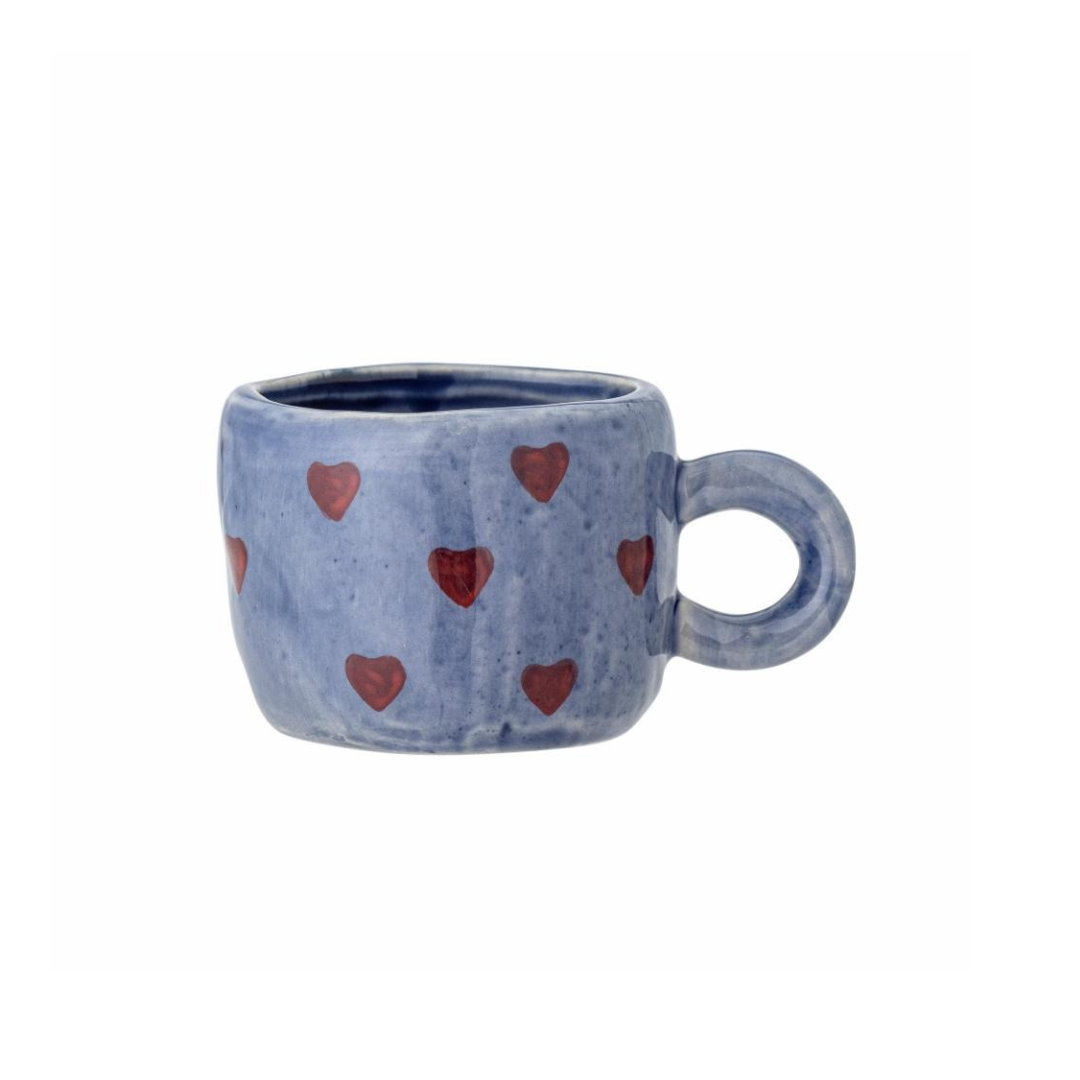 Blue mug with red heart patterns on a white background