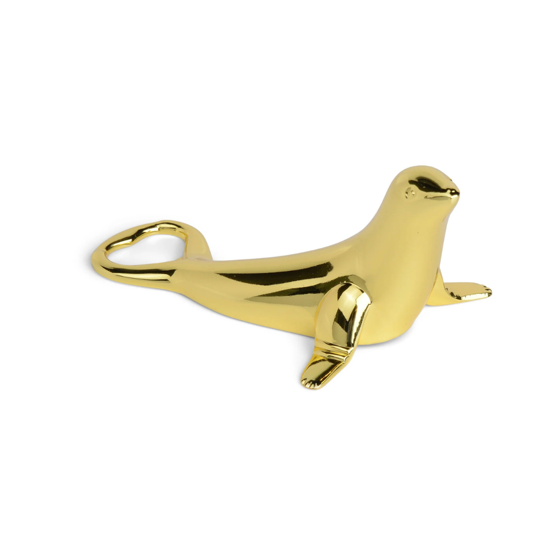 Gold seal-shaped bottle opener on a white background