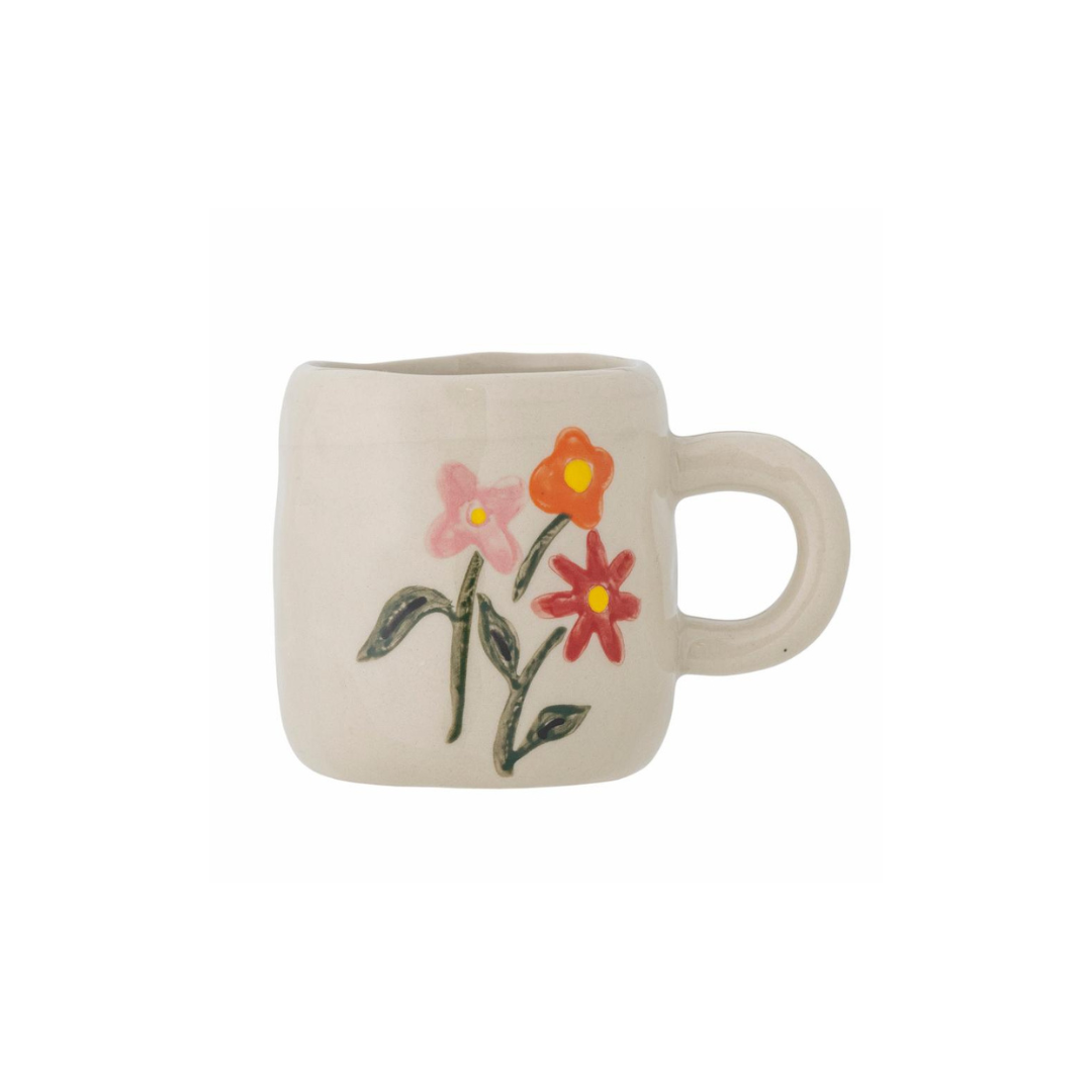 Stoneware mug with floral design on a white background