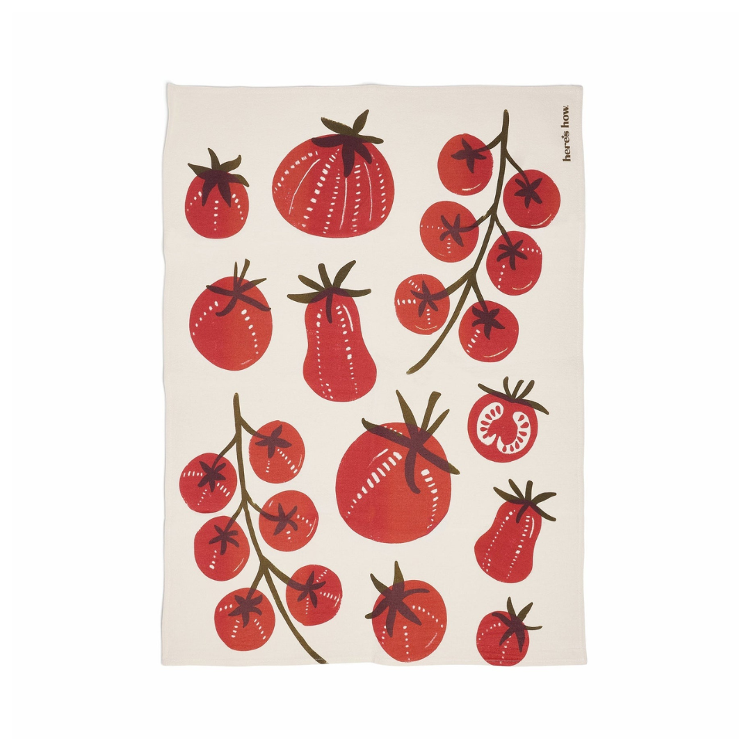 tea towel with red tomato pattern on a white background