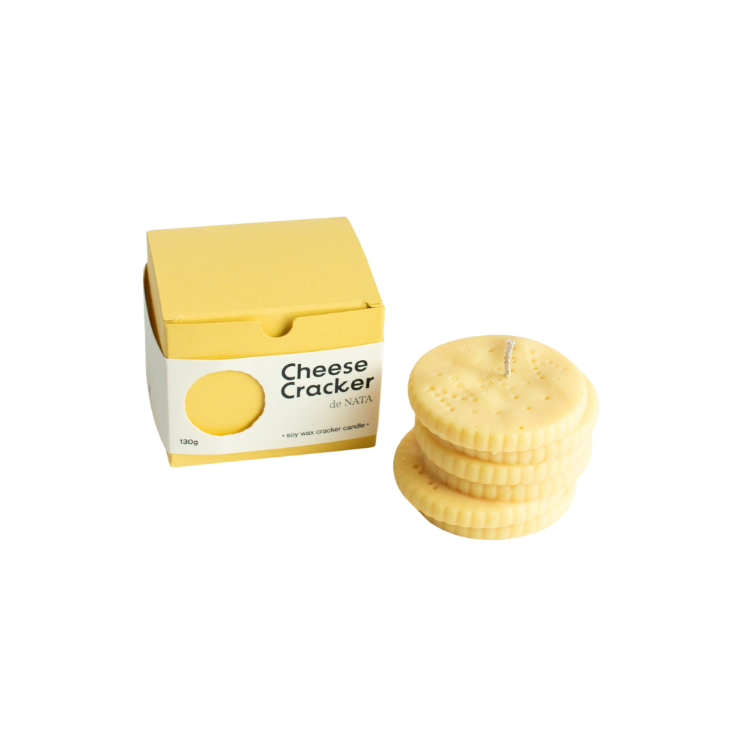 cheese crackers soy wax candle with jasmine, neroli, and orange blossom scent, shown with yellow matching packaging, handmade in the UK