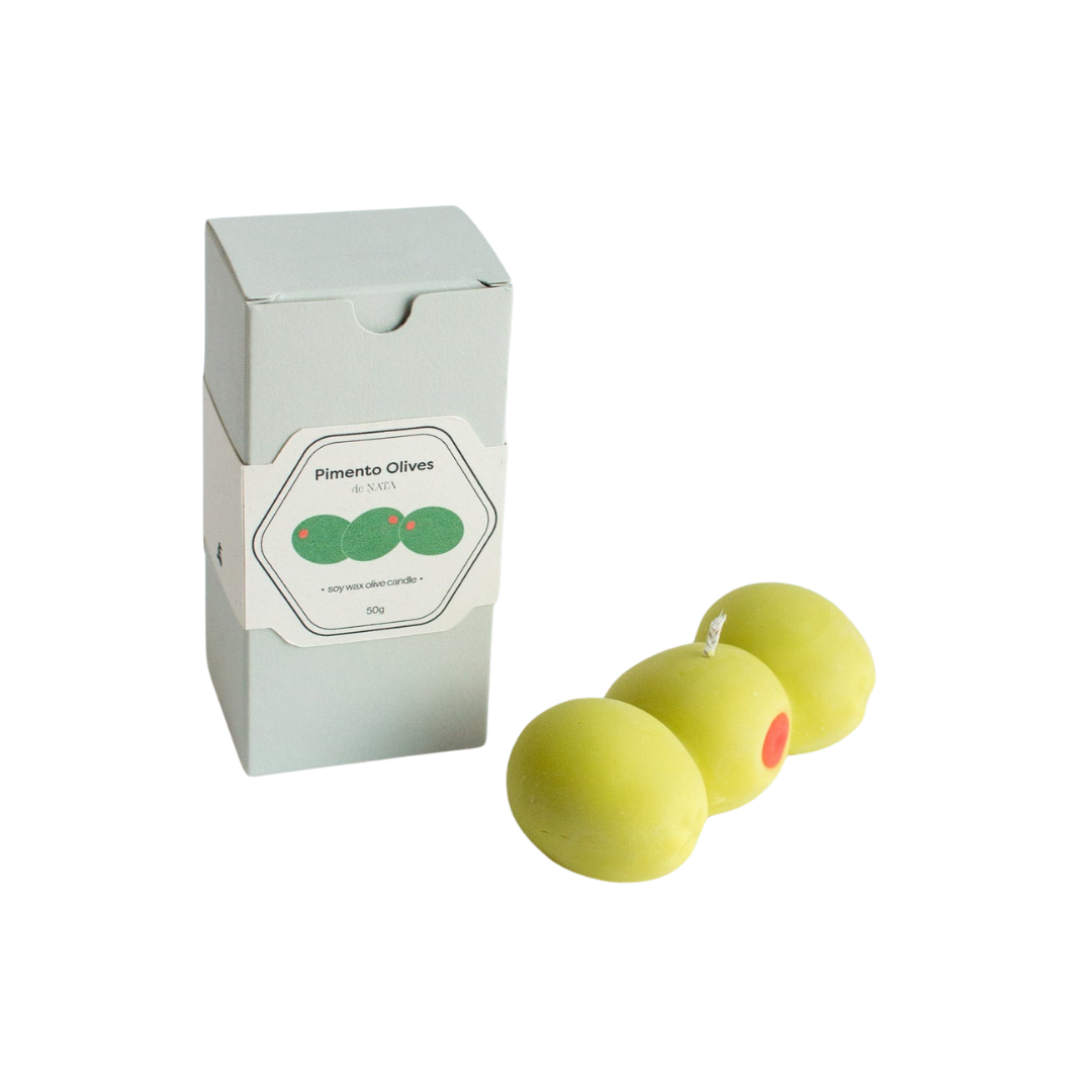 Three pimento olives soy wax candle with jasmine, neroli, and orange blossom scent, shown with yellow matching packaging, handmade in the UK