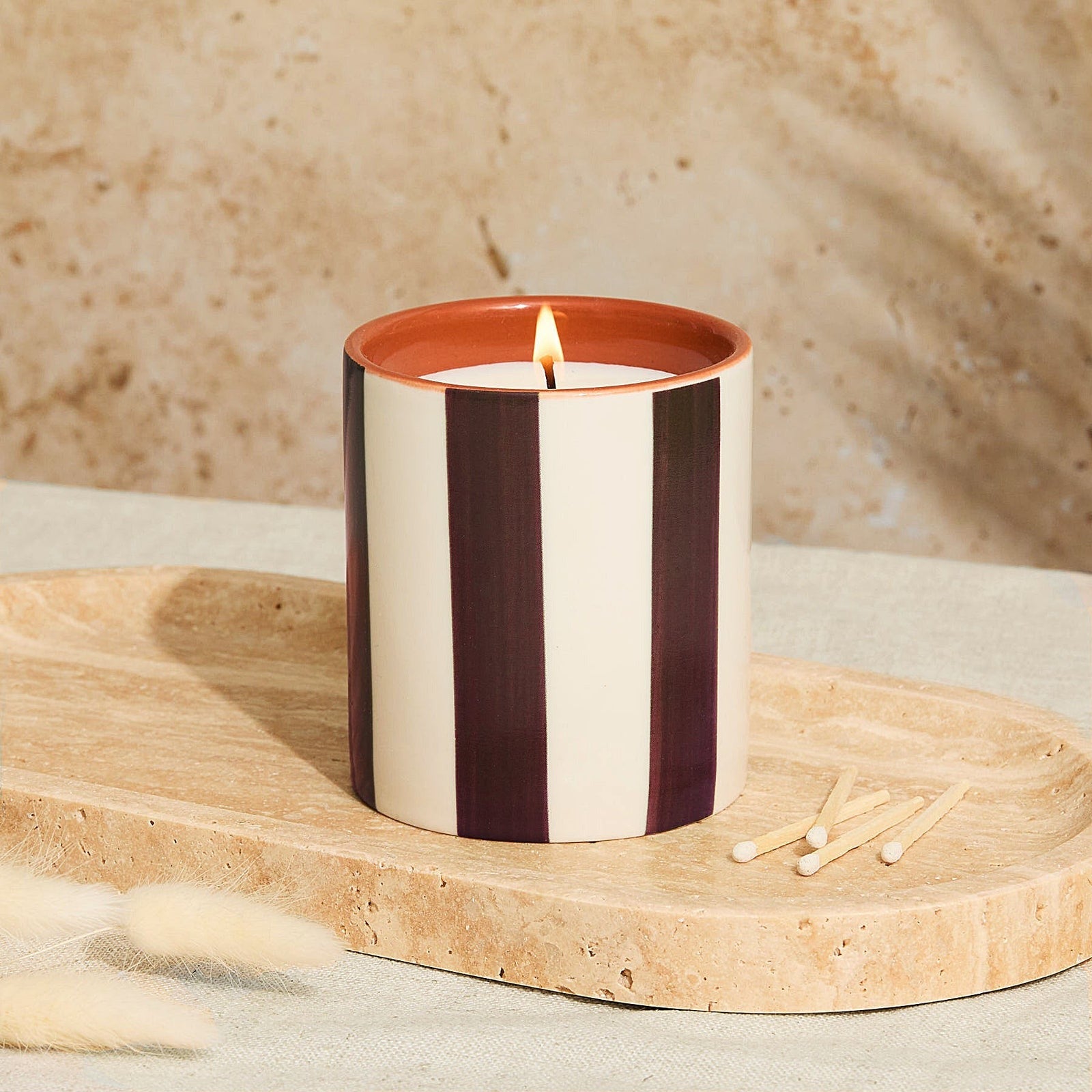 Lighting the Marrakesh ceramic tomato leaf candle with chocolate stripe design
