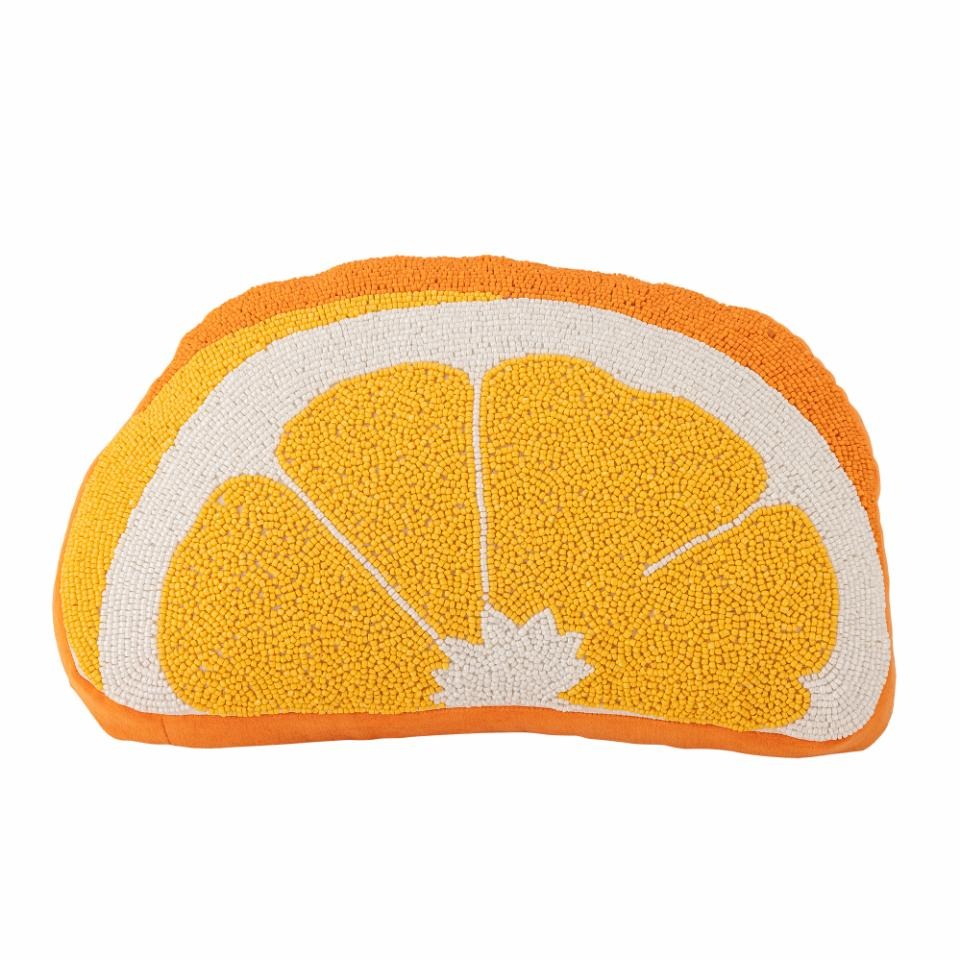 Decorative pillow shaped like an orange slice on a white background